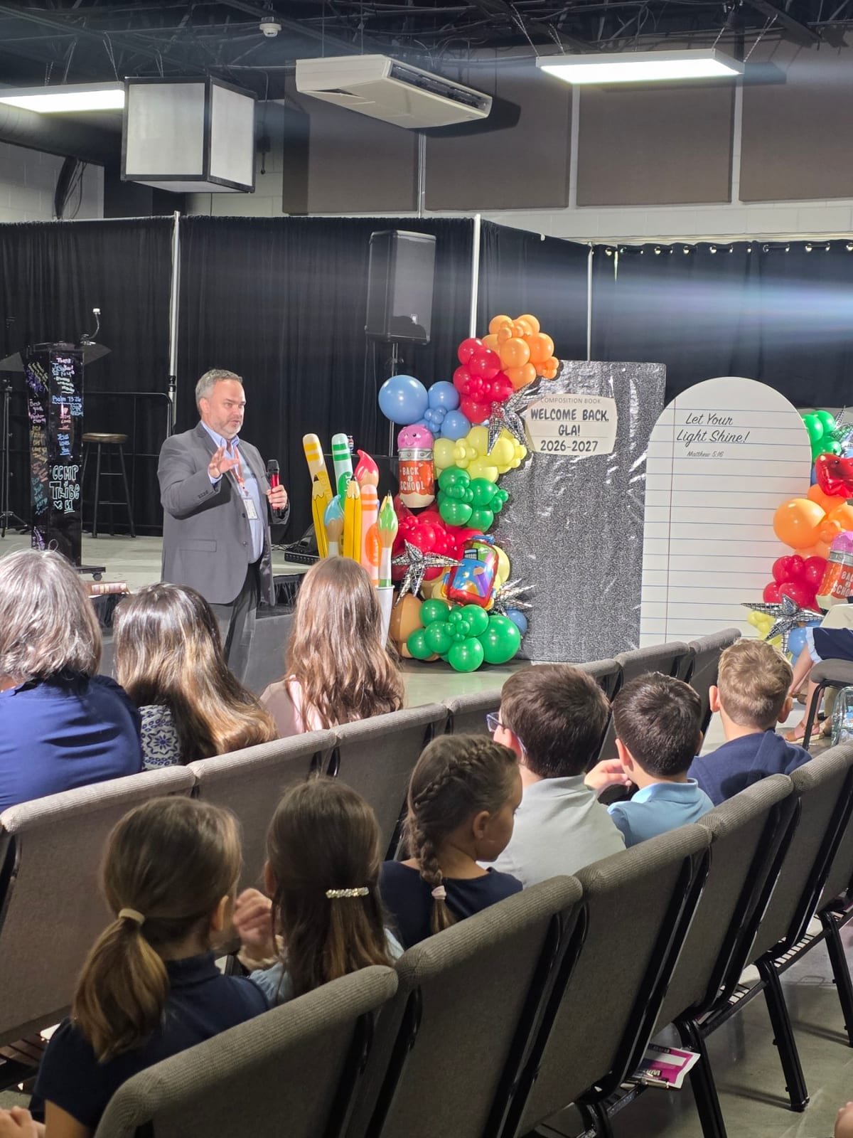 Welcome assembly with a Let Your Light Shine Matthew 5:16 display at Gospel Light Academy
